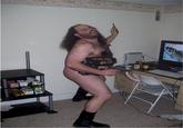 Fat hairy man in a speedo with guns and Guitar Hero controllers